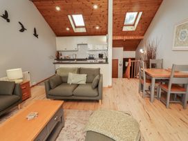 A living room with a sofa and dining table at Links View in Embleton