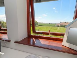 A view from a window showing a landscape and houses at Links View in Embleton