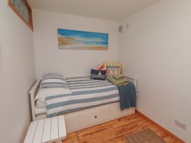 A bedroom with a bed and bedside table at Links View in Embleton