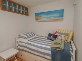 A bedroom with a bed against a wall at Links View, Embleton
