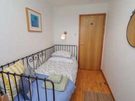 A bedroom with a bed and door at Links View in Embleton