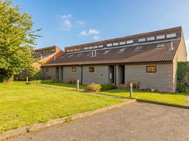 A house with benches and grass at Links View in Embleton