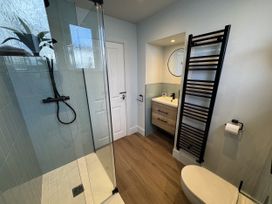 A bathroom with shower and sink at Sea Croft in Beadnell