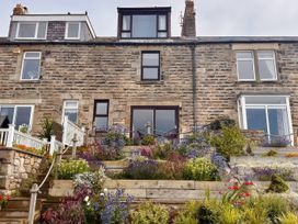 A house with plants and steps at Old Coastguard Cottages Amble