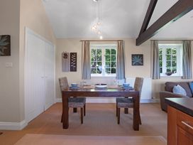 A dining room with a table and chairs at Plumtree Cottage in Alnmouth