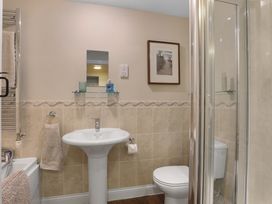 A bathroom with a sink and shower at Plumtree Cottage in Alnmouth