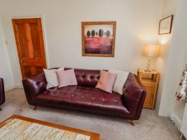 A living room with a sofa and lamp at Hardys House in Alnwick