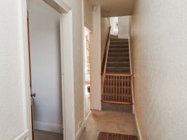 A hallway with a staircase and a gate at Hardys House in Alnwick