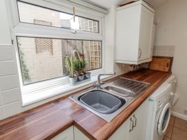 A kitchen with a sink and a washing machine at Hardys House in Alnwick