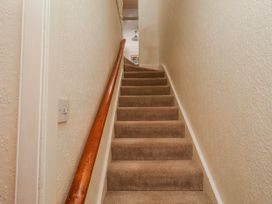 A staircase with carpet and a handrail at Hardys House in Alnwick