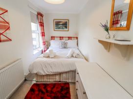 A bedroom with a bed and dresser at Hardys House Alnwick