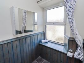 A bathroom with a mirror and window at Hardys House in Alnwick