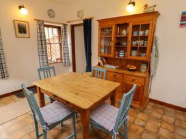 A dining room with a wooden table and chairs at Lavender Cottage (Bailiffgate) Alnwick