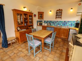 A kitchen with wooden furniture and appliances at Lavender Cottage (Bailiffgate) Alnwick
