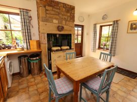A kitchen with a table and chairs at Lavender Cottage (Bailiffgate) Alnwick