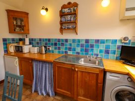 A kitchen with a sink and appliances at Lavender Cottage (Bailiffgate) Alnwick