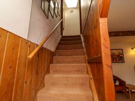 A staircase with carpet and framed pictures at Lavender Cottage (Bailiffgate) Alnwick