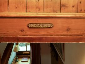 A wooden sign labeled Duck or Grouse in a hallway at Lavender Cottage (Bailiffgate) in Alnwick