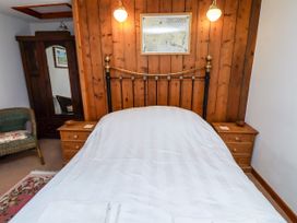 A bedroom with a bed and nightstands at Lavender Cottage (Bailiffgate) Alnwick