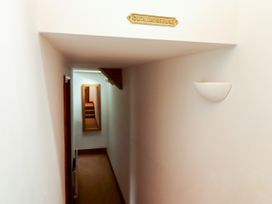 A hallway with a mirror and stairs at Duck of Grouse in Alnwick