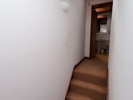 A hallway with stairs leading to a bathroom at Lavender Cottage (Bailiffgate) Alnwick