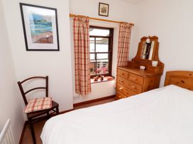 A bedroom with a bed and dresser at Lavender Cottage (Bailiffgate) Alnwick