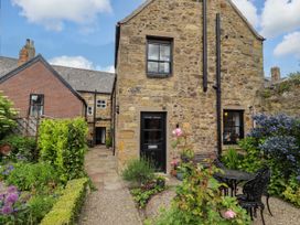 A house with a garden and seating area at Lavender Cottage (Bailiffgate) Alnwick