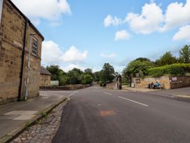 An outdoor view of a road with buildings and trees at Lavender Cottage (Bailiffgate) Alnwick
