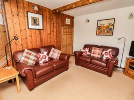 A living room with two sofas and a television at Lavender Cottage (Bailiffgate) Alnwick