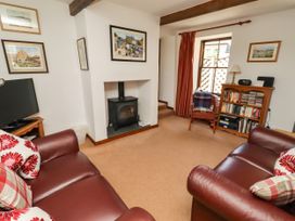 A living room with a television and fireplace at Lavender Cottage (Bailiffgate) Alnwick