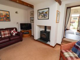 A living room with a fireplace and a television at Lavender Cottage (Bailiffgate) Alnwick