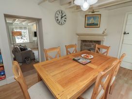 A dining room with a table and chairs at Marie's Cottage in Craster
