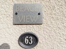 A property sign indicating Beach View and the house number 63 at Beach View in Seahouses