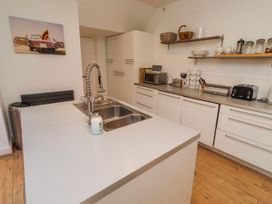 A kitchen with a sink and appliances at Alnbank in Alnmouth