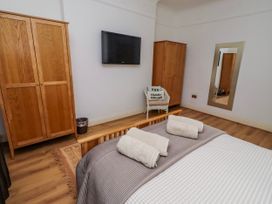 A bedroom with a bed and wardrobe at Alnbank in Alnmouth