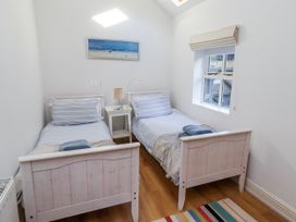 A bedroom with two single beds and a bedside table at Alnbank in Alnmouth