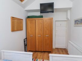 A bedroom with a wardrobe and television at Alnbank in Alnmouth