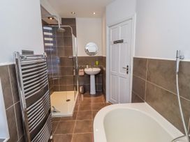 A bathroom with shower and bathtub at Alnbank in Alnmouth