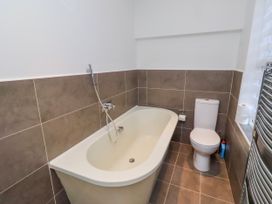 A bathroom with a bathtub and toilet at Alnbank in Alnmouth