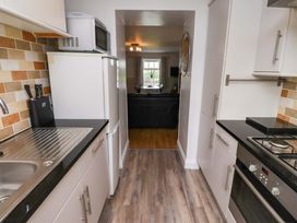 A kitchen with a sink and refrigerator at Heather Cottages - Brent Goose in Bamburgh