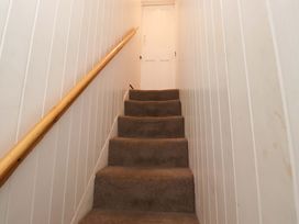 A stairway leading to a door at Heather Cottages - Brent Goose in Bamburgh
