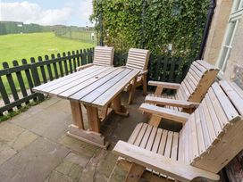 A table and chairs in an outdoor seating area at Heather Cottages - Brent Goose Bamburgh