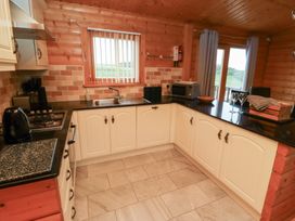 A kitchen with a sink and appliances at Heather Cottages - Brown Owl Bamburgh