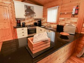 A kitchen with appliances and wooden features at Heather Cottages - Brown Owl in Bamburgh