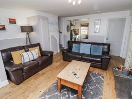 A living room with sofas and a coffee table at Heather Cottages - Godwit in Bamburgh