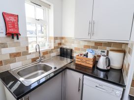 A kitchen with a sink and kettle at Heather Cottages - Godwit in Bamburgh