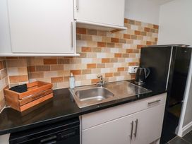 A kitchen with a sink and refrigerator at Heather Cottages - Grayling Bamburgh