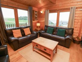 A living room with sofas and a coffee table at Heather Cottages - Grey Heron in Bamburgh