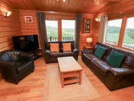A living room with a television and sofas at Heather Cottages - Grey Heron in Bamburgh