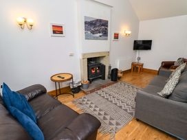 A living room with a sofa and fireplace at Heather Cottages - Grey Seal in Bamburgh